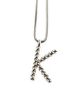 Pendant "K" on a silver chain