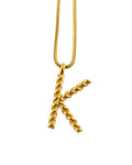 Pendant "K" on a gold chain